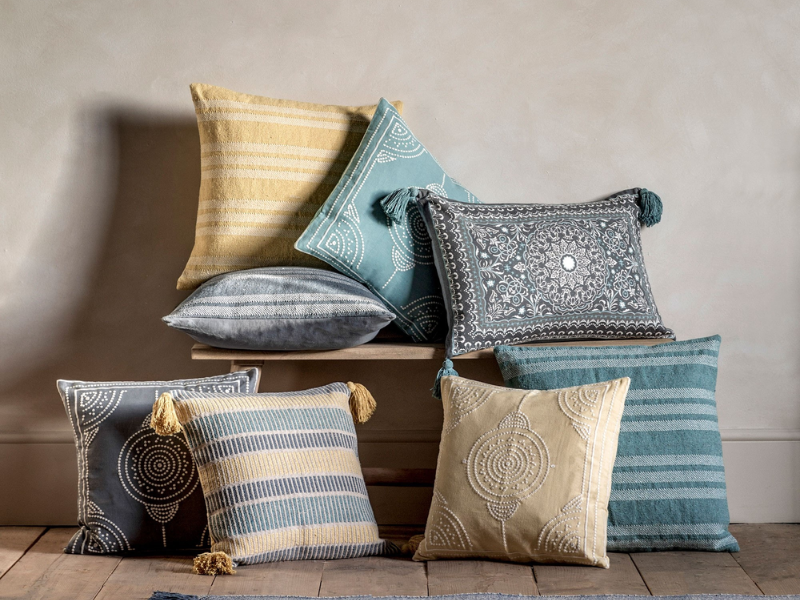 Collection of decorative throw pillows in various colors and patterns